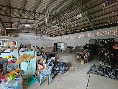 Spacious storage area with high ceiling and various items