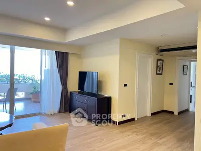 Spacious living room with modern decor and large balcony access.