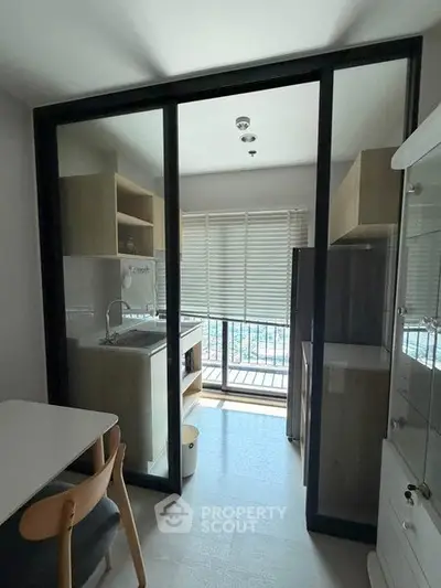 Modern kitchen with glass sliding doors and balcony view