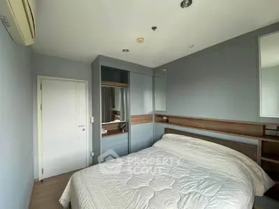Cozy bedroom with modern design and ample storage in a stylish apartment.