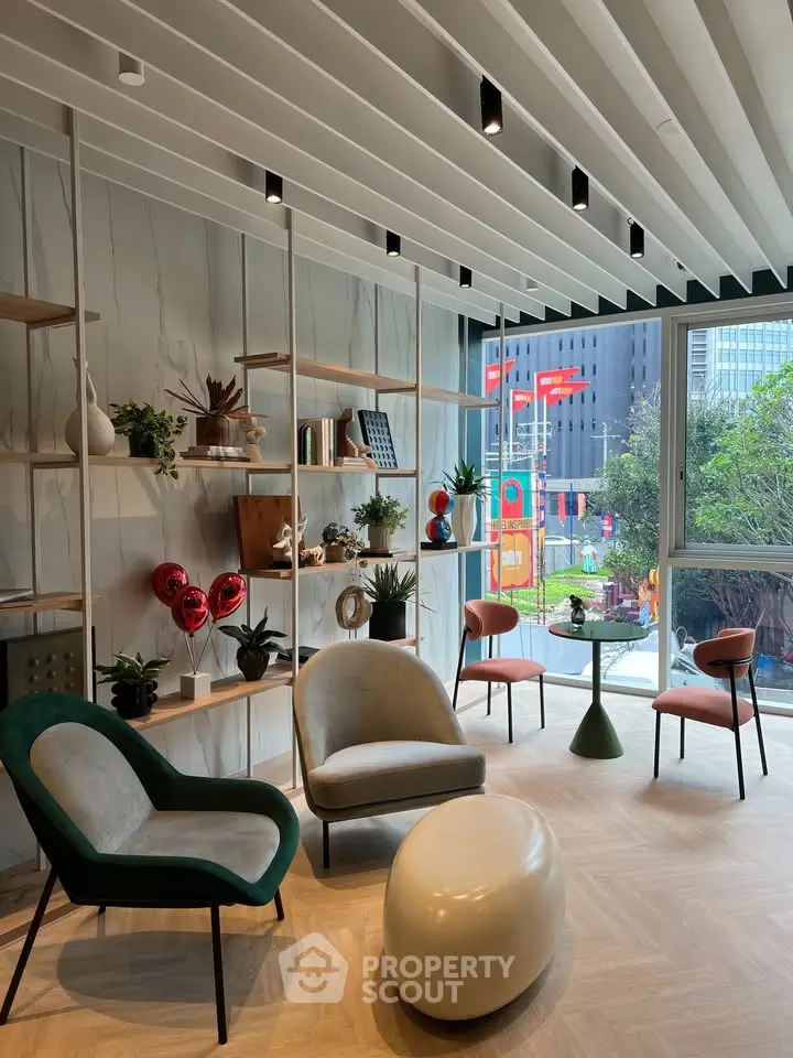 Modern living room with stylish furniture and large window offering city view
