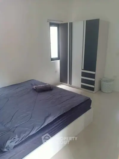 Spacious bedroom with modern wardrobe and natural light