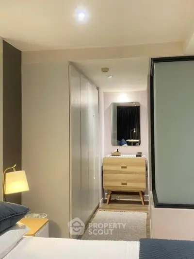 Modern bedroom with sleek furniture and ambient lighting, showcasing a stylish and cozy interior design.