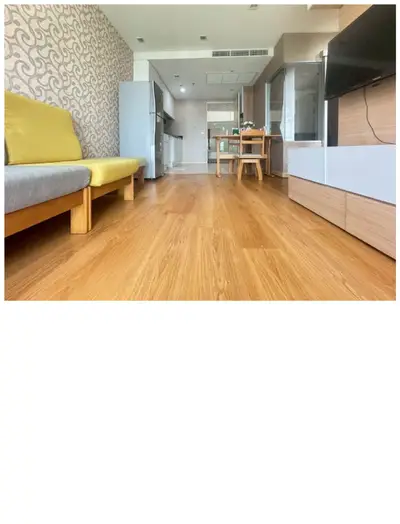 Spacious modern living room with wooden flooring and stylish furniture