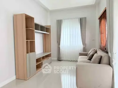 Spacious living room with modern furniture and large windows for natural light.