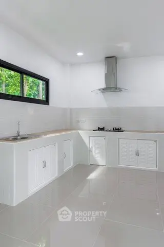 Modern kitchen with sleek white cabinets and gas stove