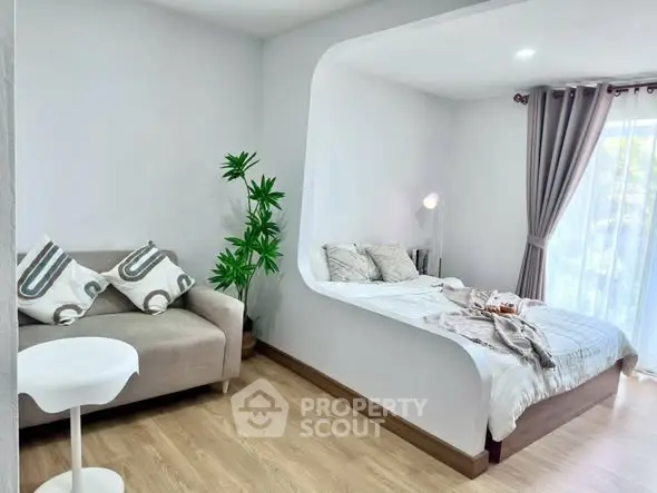 Modern studio apartment with cozy bed and stylish decor