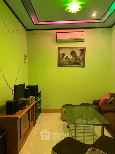 Cozy living room with vibrant green walls, modern furniture, and ambient lighting