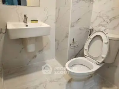 Modern bathroom with marble tiles and sleek fixtures