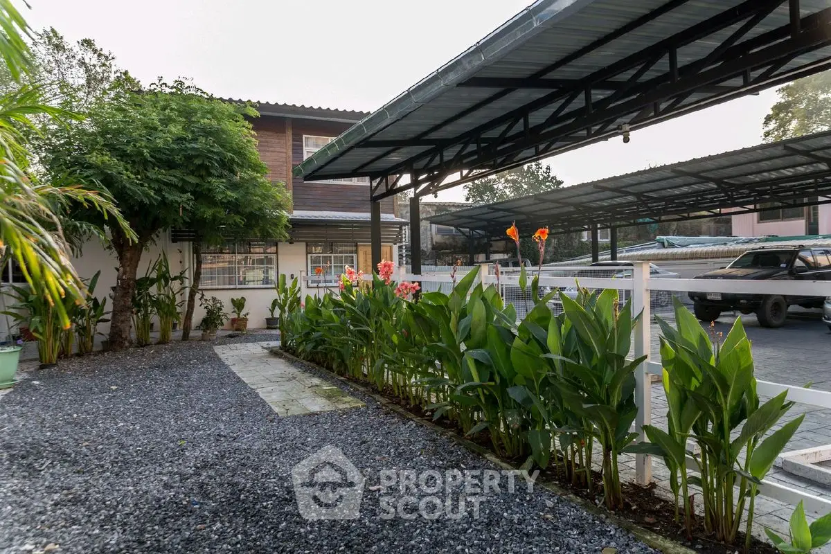 Charming garden view with lush greenery and spacious parking area