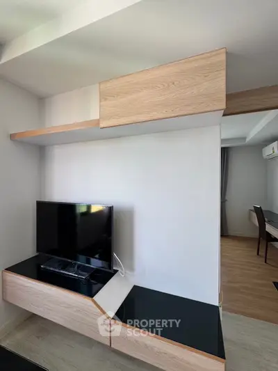 Modern living room with sleek TV unit and stylish wooden accents