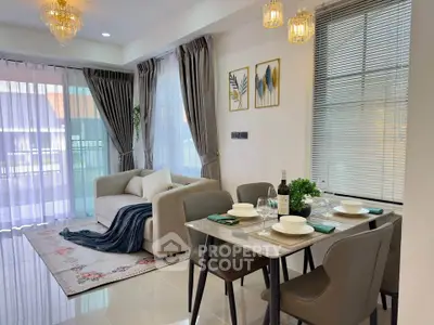 Elegant living room with modern decor, cozy sofa, dining table, and stylish lighting in a bright, airy space.