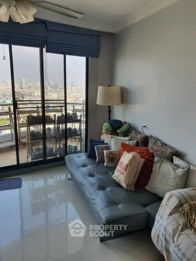 Chic living room with city view and cozy seating area in modern apartment.