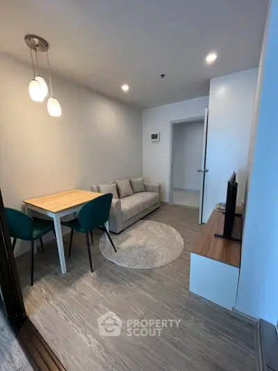 Modern living room with cozy sofa and dining area in stylish apartment.