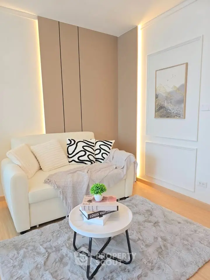 Stylish living room with cozy sofa, modern decor, and elegant lighting in a contemporary apartment.