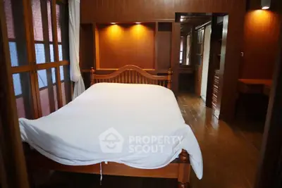 Cozy bedroom with wooden furniture and ambient lighting