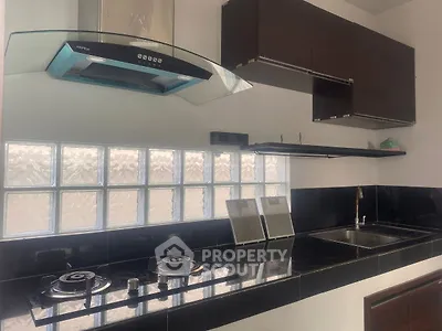 Modern kitchen with sleek black countertops and built-in gas stove