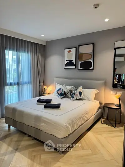 Modern bedroom with stylish decor and large window for natural light