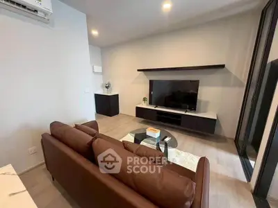 Modern living room with sleek furniture and wall-mounted TV, perfect for relaxation and entertainment.