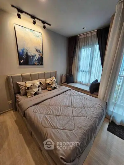 Modern bedroom with stylish decor and large window for natural light