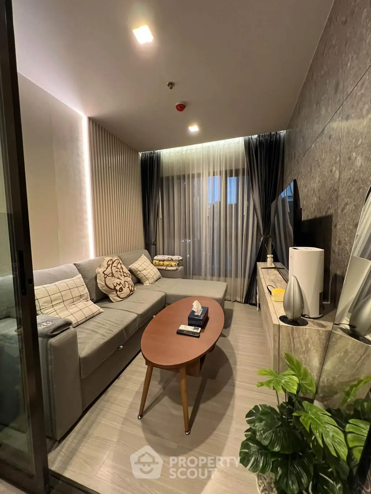 Modern living room with stylish decor and cozy seating area, perfect for relaxation and entertainment.