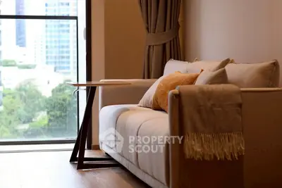 Elegant living room with modern sofa and city view window, perfect for urban living.