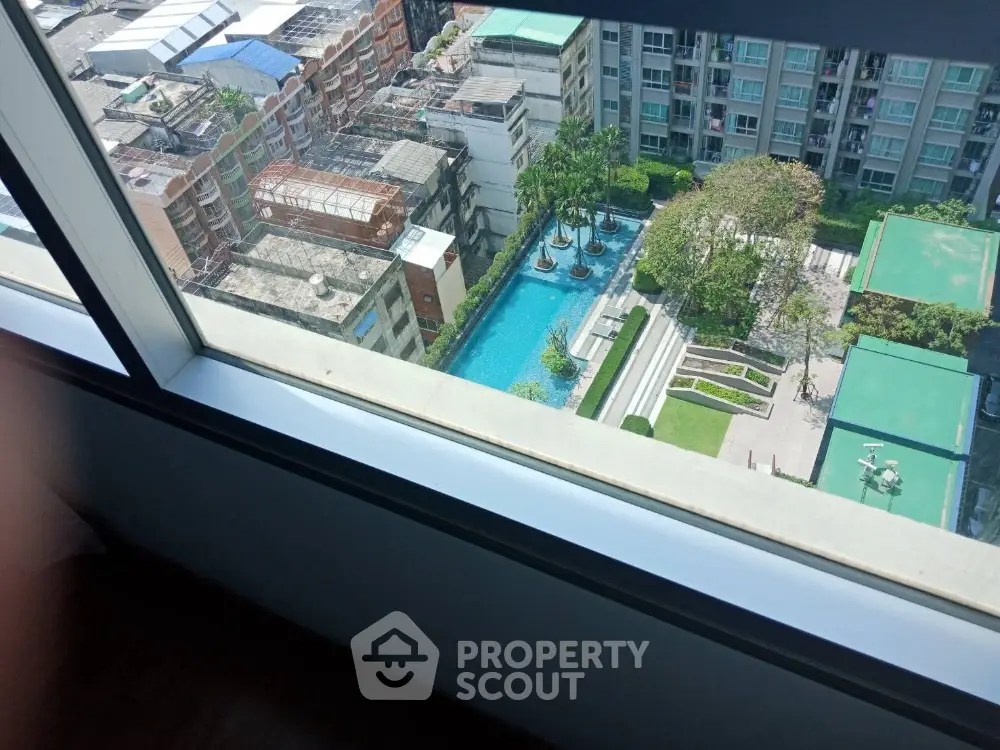 Stunning aerial view of modern condominium with pool and lush garden