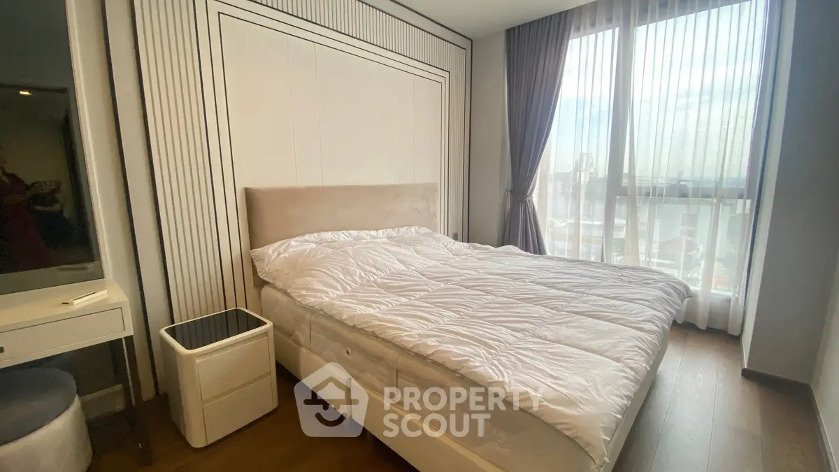 Modern bedroom with large window and elegant decor