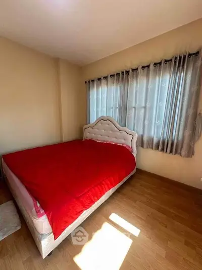 Cozy bedroom with red bedding and natural light