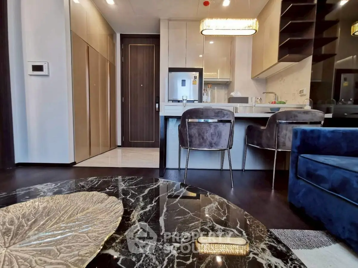 Modern open-layout kitchen with sleek design and luxurious finishes in a stylish apartment.