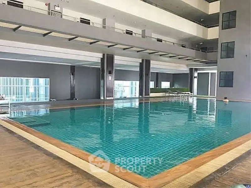 Luxurious indoor swimming pool in modern residential building with sleek design.