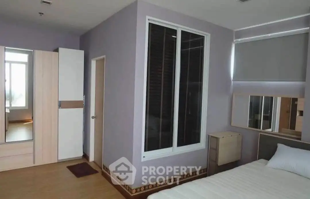 Spacious bedroom with modern design and ample natural light