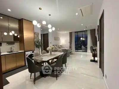 Luxurious open-plan living and dining area with modern kitchen and elegant lighting.