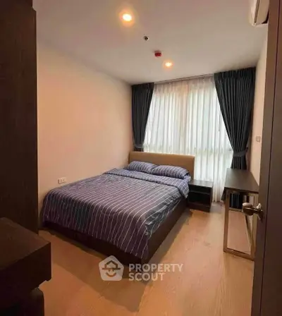 Cozy bedroom with modern decor and natural light, featuring a comfortable bed and stylish curtains.