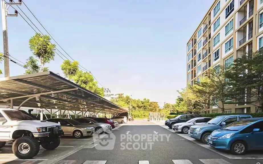 Spacious parking area in modern residential complex with ample greenery and well-maintained surroundings.