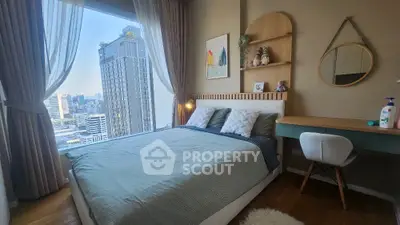 Modern bedroom with city view, stylish decor, and natural light