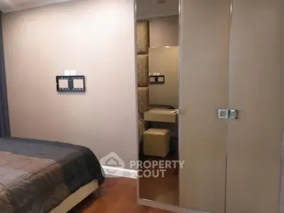 Modern bedroom with mirrored wardrobe and cozy decor