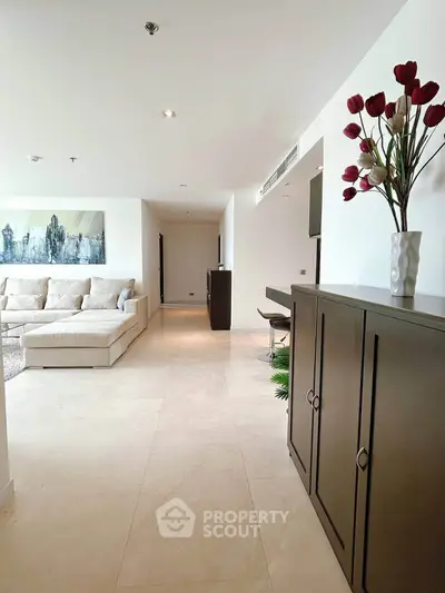 Spacious modern living room with elegant decor and comfortable seating in a luxury apartment.