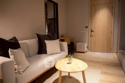 Modern living room with cozy sofa and stylish decor in a contemporary apartment.