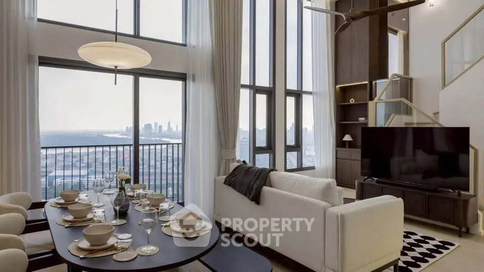 Luxurious high-rise living room with stunning city and sea views, featuring elegant decor and floor-to-ceiling windows.