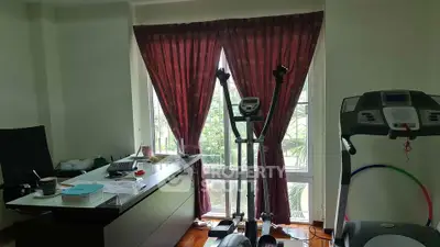 Home office with exercise equipment and large window with curtains