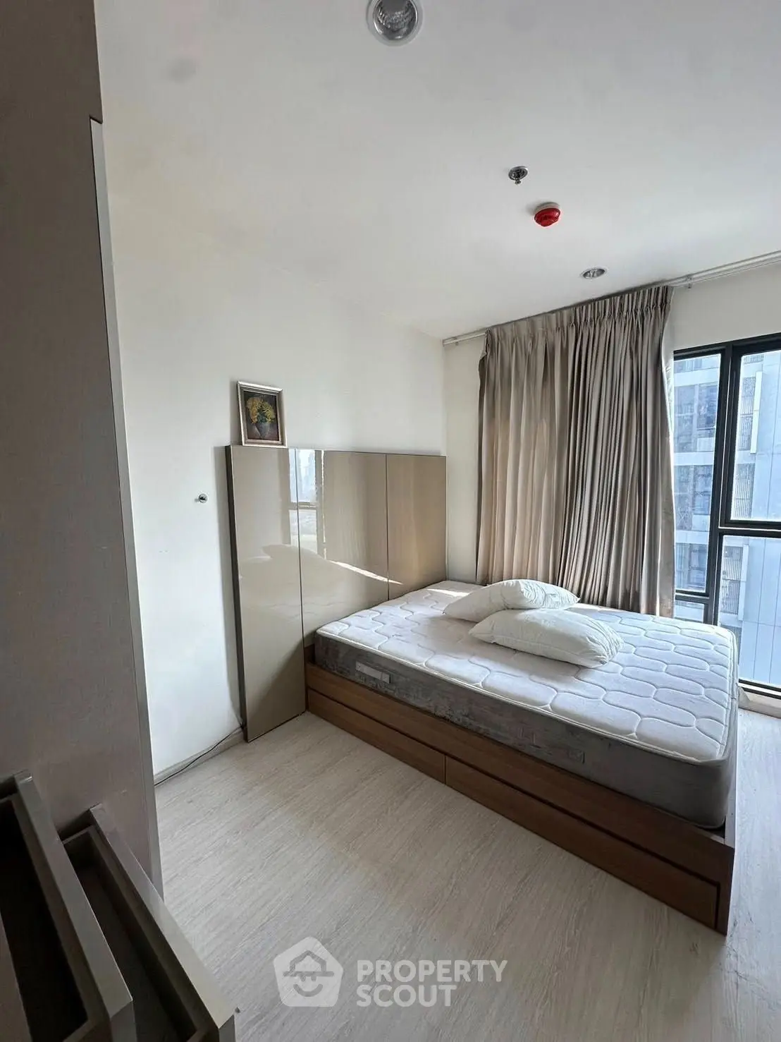 Bright modern bedroom with large window and minimalist decor