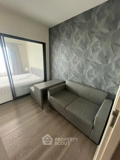 Modern apartment with stylish geometric accent wall and cozy furniture