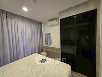 Modern bedroom with sleek design, featuring a comfortable bed, stylish wardrobe, and elegant vanity area.