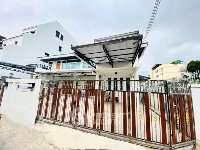 Modern white house with gated entrance and spacious driveway