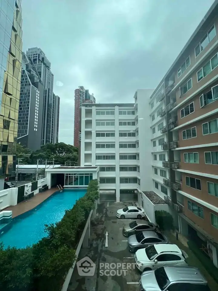 Modern urban apartment complex with pool and parking view