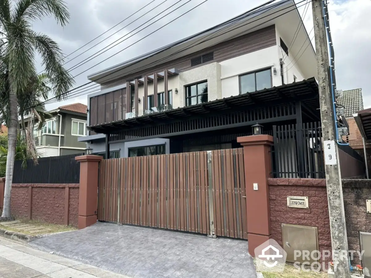 Modern two-story house with gated entrance and contemporary design