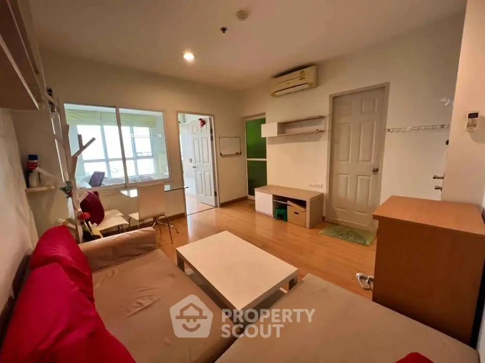 Cozy living room with modern furniture and wooden flooring in a stylish apartment.