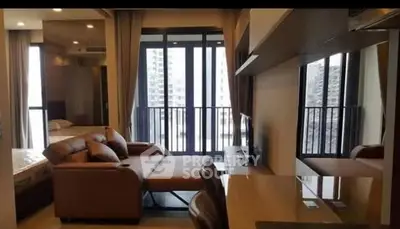 Modern living room with balcony view and stylish furniture