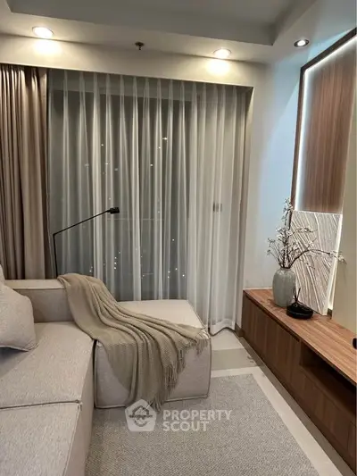 Modern living room with cozy sofa and elegant decor, perfect for relaxation.